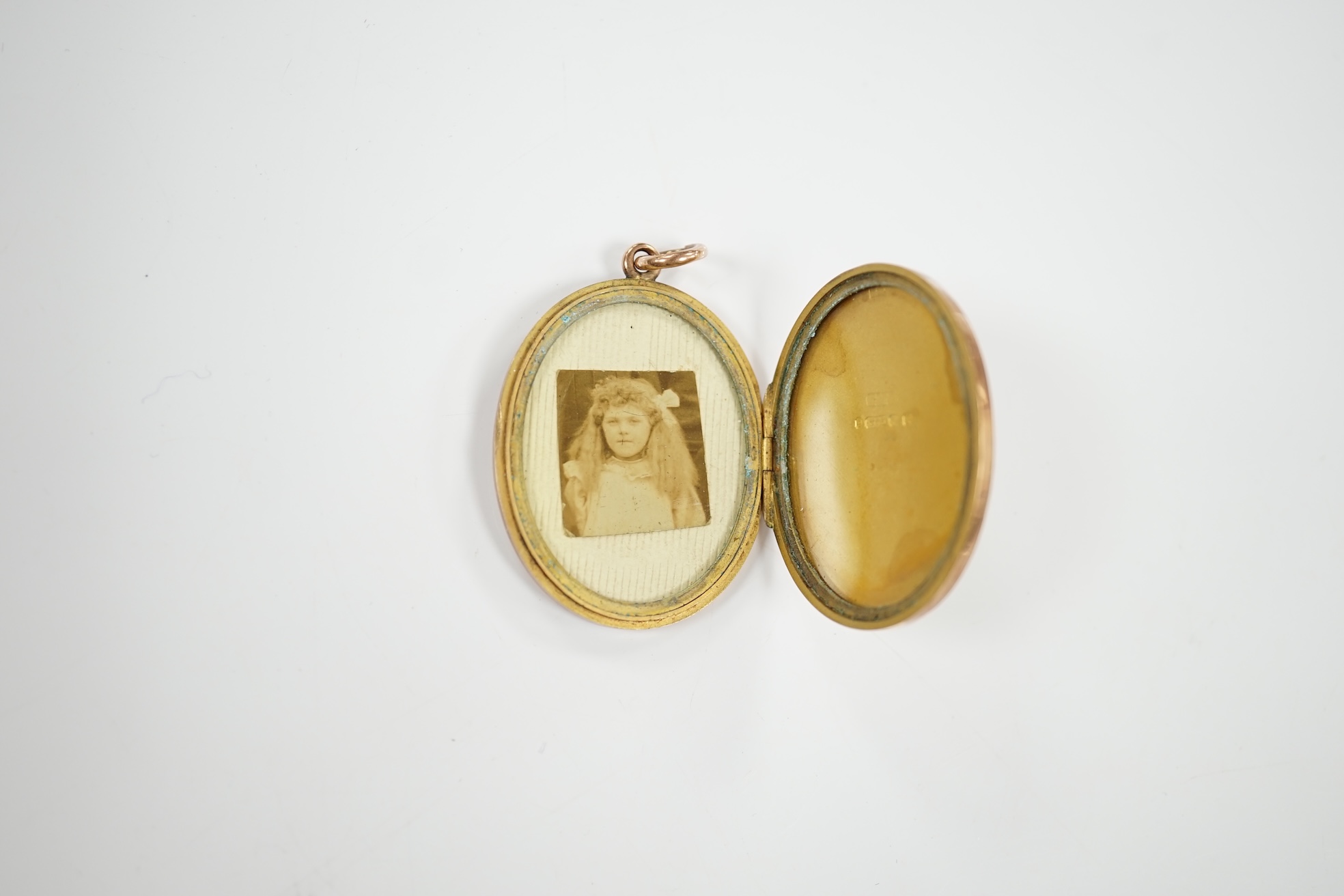 A George V engraved 9ct gold oval locket, 35mm, gross weight 11.7 grams. Condition - fair to good